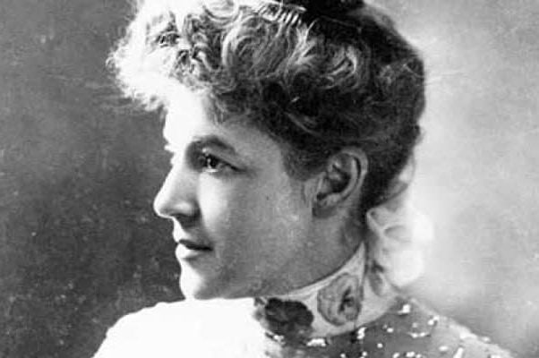 A black and white portrait of American poetess Ella Wheeler Wilcox