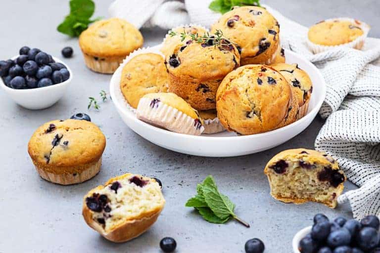 healthy-vegan-banana-blueberry-muffins-white-ceramic-bowl-with-fresh-berries-thyme-mint