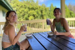 Two volunteers enjoy a vegan breakfast at Gentle World's visitor center in Hawaii